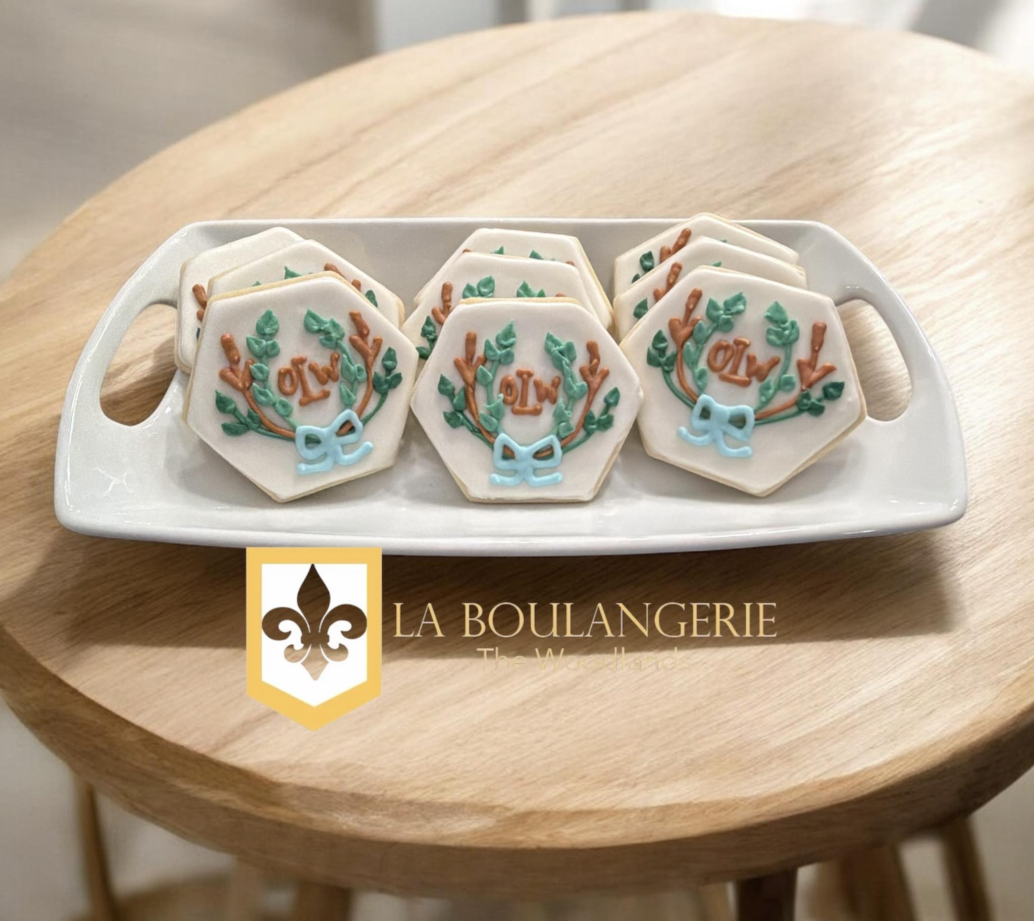 Custom decorated cookies with monogram and leaf designs by La Boulangerie