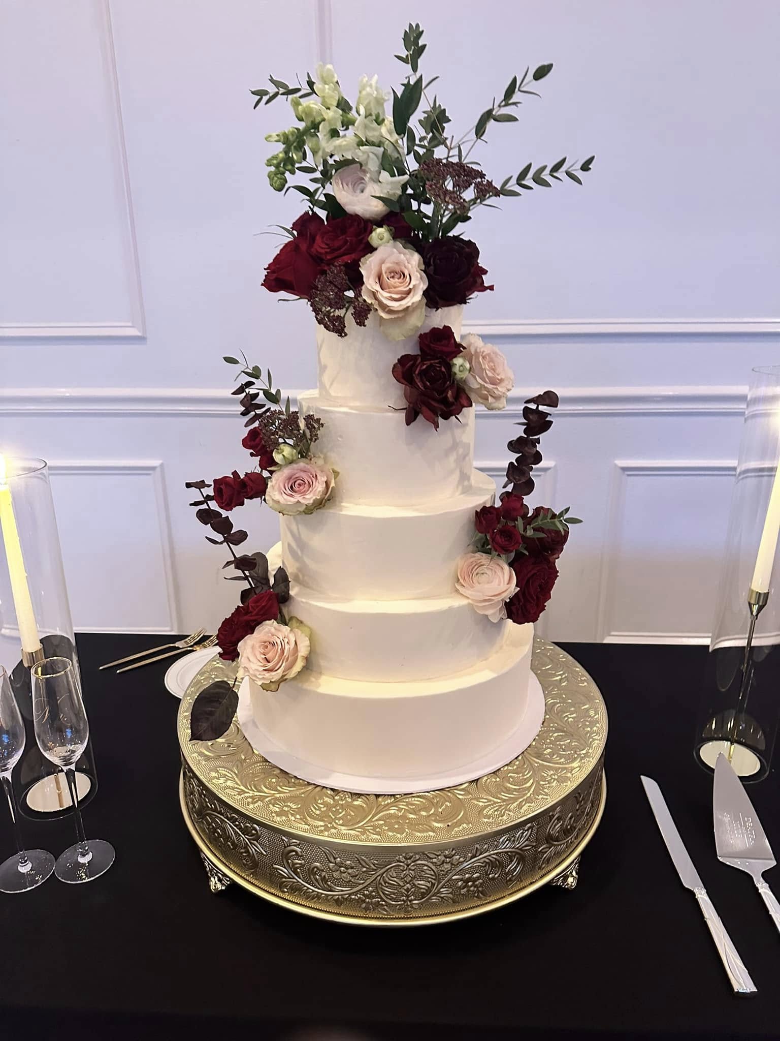 Elegant five-tier wedding cake with burgundy and blush roses by La Boulangerie